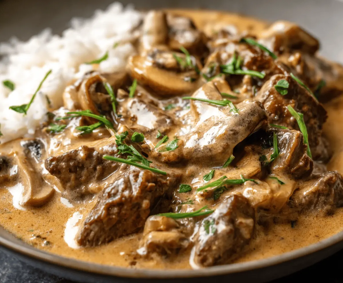 Creamy beef stroganoff featuring tender beef strips and rich mushroom sauce served over noodles, prepared by Gordon Ramsay.